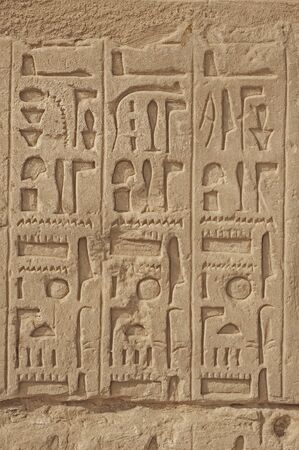 Hieroglypic carvings on wall at the ancient egyptian Karnak temple in Luxor