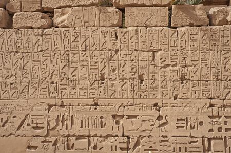 Hieroglypic carvings on wall at the ancient egyptian Karnak temple in Luxor