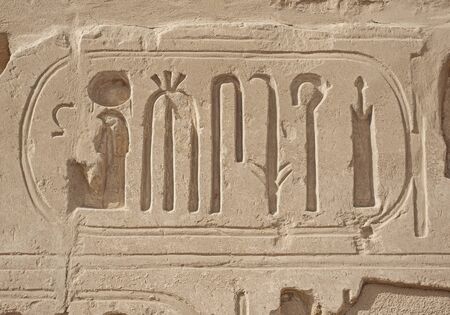 Hieroglypic carvings on wall at the ancient egyptian Karnak temple in Luxor