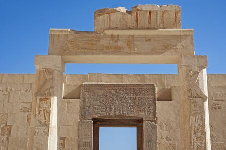 Hieroglypic carvings on entrance doorway wall at the ancient egyptian Temple of Hatshetup in Luxor