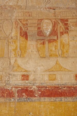 Hieroglypic carvings and paintings on wall at the ancient egyptian temple of hatshetup in Luxorの写真素材