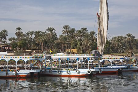 Traditional egyptian felluca sailing boat on river Nile with reflectionの写真素材