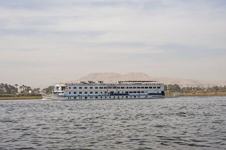 Large luxury traditional Egyptian river cruise boat sailing on the Nileの写真素材