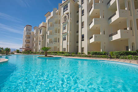 Large swimming pool with garden at a luxury tropical hotel resortの写真素材