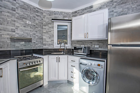 Interior design decor showing modern kitchen and appliances in luxury apartment showroomの写真素材