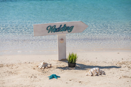 Closeup of wedding sign on tropical island sandy beach paradise with ocean in backgroundの写真素材