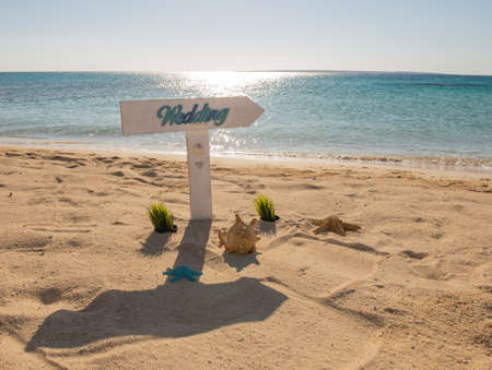 Closeup of wedding sign on tropical island sandy beach paradise with ocean in backgroundの写真素材