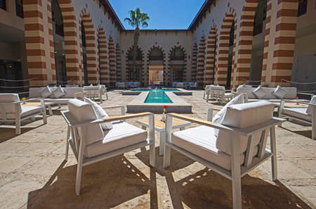 Outdoor patio terrace seating cafe area with table and chairs at tropical luxury hotel resortの写真素材
