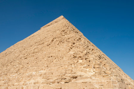 Large stone ancient egyptian pyramid tomb at the giza plateau necropolis in Cairo