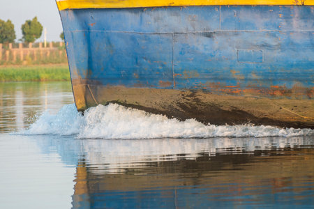 Closeup of bow on industrial river barge boat vessel traveling along large river in Africaの写真素材