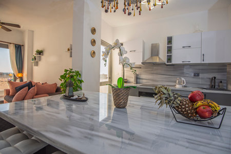 Living room lounge area in luxury apartment show home showing interior design decor furnishing with open plan kitchenの写真素材