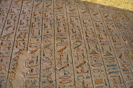 Hieroglypic carvings on wall in the ancient egyptian tomb of ramses III in Luxor Valley of the Kings