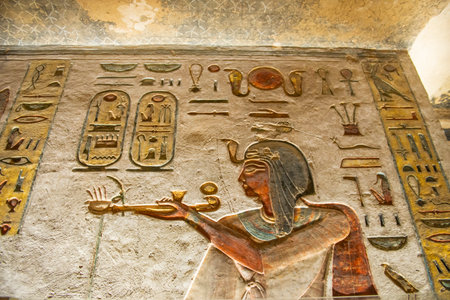 Hieroglypic carvings on wall in the ancient egyptian tomb of ramses III in Luxor Valley of the Kingsの写真素材