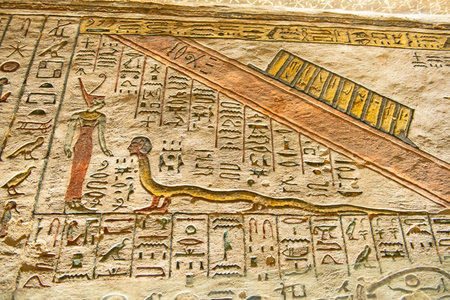 Hieroglypic carvings on wall in the ancient egyptian tomb of ramses III in Luxor Valley of the Kings