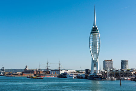 Landscape view of the entrance to Portsmouth harbour with The Spinnaker Tower Sail of the Solent landmark against a blue sky backgroundの写真素材