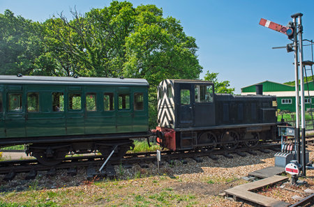 Old historical traditional heritage diesel engine locomotve train travelling on tracks in rural...