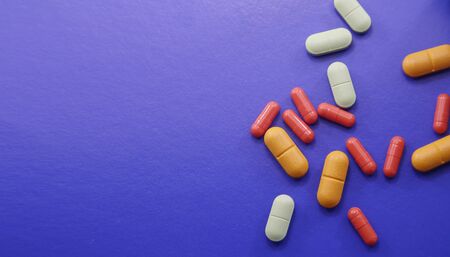 Assorted pharmaceutical medicine pills, tablets and capsules.Pills background. Heap of assorted various medicine tablets and pills different colors on background. Health careの写真素材