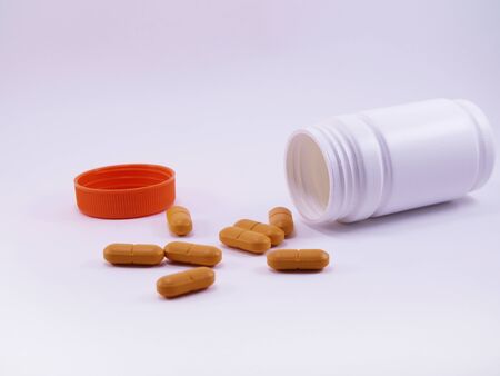 Assorted pharmaceutical medicine pills, tablets and capsules and bottle on white background. Copy space for textの写真素材