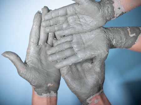 Female potter works with clay, craftsman hands close up, kneads and moistens the clay before work