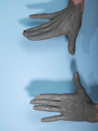Female potter works with clay, craftsman hands close up, kneads and moistens the clay before workの写真素材