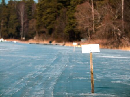 a sign on the lake's ice forbidding drilling ice. blank for your text. sign with empty spaceの写真素材