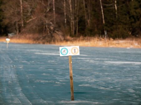 a sign on the lake's ice forbidding drilling ice. blank for your text. sign with empty spaceの写真素材