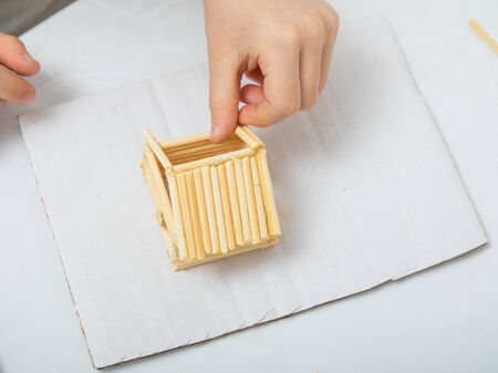 step-by-step instructions for creating a house from bamboo sticks. children's creativity, manual work, online classes. step 6. construction of the roof of the house from bamboo sticksの写真素材
