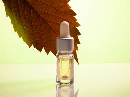 Dropper glass bottle mock-up. cosmetic pipette isolated on yellow background. Premium Photoの写真素材