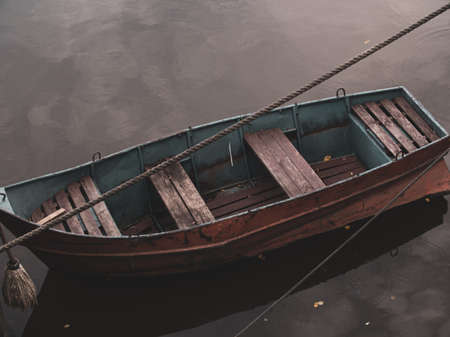 wooden boat moored to the shore by cableの写真素材