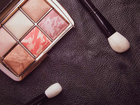 premium cosmetics on a black background. brushes, mascara and powderの写真素材