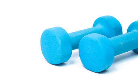 blue fitness dumbbells on a white background. the concept of a healthy lifestyle. fitness attributesの写真素材