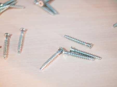 furniture screws on the background of assembled furniture in the apartment.