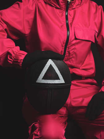 Moscow, Russia- 08 Novemnver 2021: Guard from Squid Game sitting holding mask in hand. corean survival showのeditorial素材
