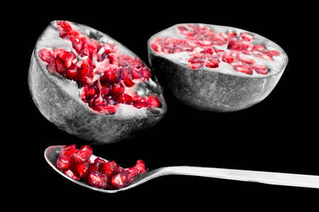 Stylised image of pomegranate with tinted seeds on black and whiteの写真素材