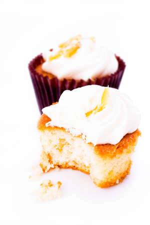 Pair of fancy cream cup cakes on whiteの写真素材