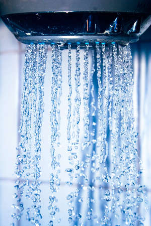 Shower head with water droplets captured in detailの写真素材