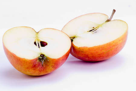 A freshly halved apple over white backgroundの写真素材