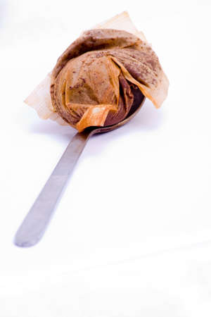 A used tea bag on a silver spoonの写真素材