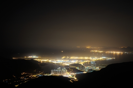 The night view of Lantau Island, Hong Kong, looking from the hill. In the middle is the airportの写真素材