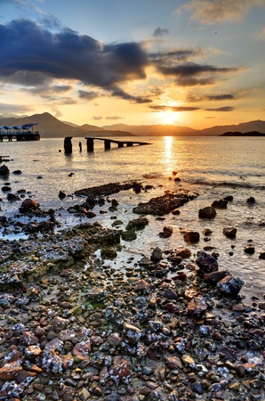 Sunset on a rocky beach in Hong Kong.の写真素材