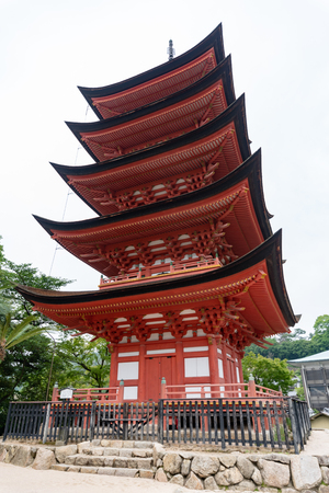 Miyajima, Japan - JUNE 27 2017: Toyokuni Shrine five-story pagoda at Torii Gate at Miyajima, Hiroshima, Japan at the floating gate of Itsukushima Shrine.のeditorial素材