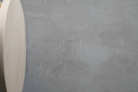 Round wood table with cement background emptyの写真素材