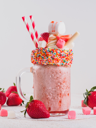 Pink strawberry freakshake with sweetsの写真素材