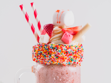 Pink strawberry freakshake with sweetsの写真素材
