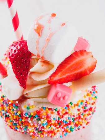 Pink strawberry freakshake with sweetsの写真素材