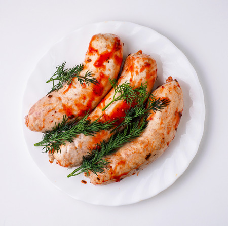 Raw sausage on white plate. Isolated.の写真素材