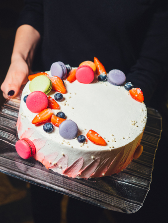 cake with macarons and berriesの写真素材
