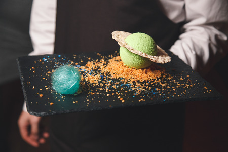 dessert in waiter handの写真素材