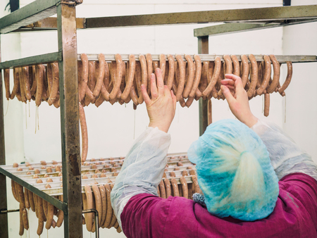 Preparation of sausage in productionの写真素材