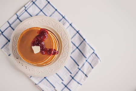 Pancakes with butter and jam on the plate.の写真素材